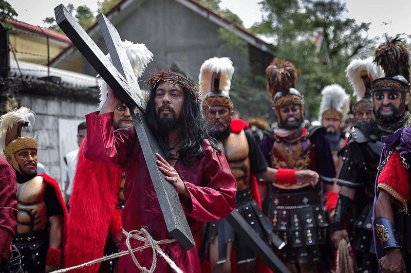 Celebrants dressed as moriones and Jesus for the Moriones festival