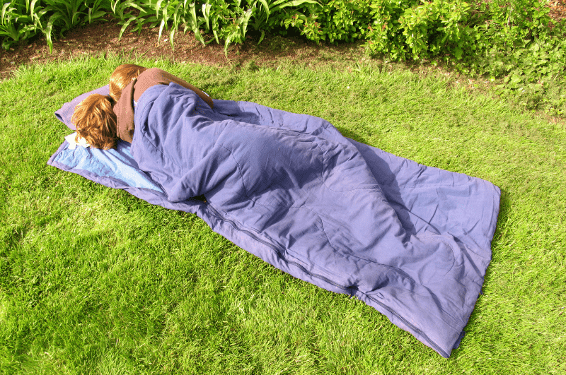 person sleeping in a rectangular sleeping bag