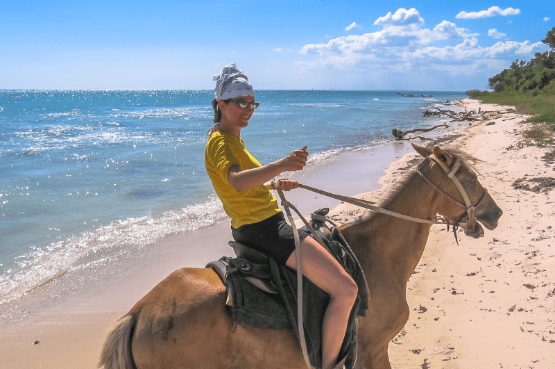 Person riding a horse on the beach