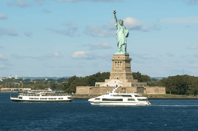 Tour boats in front of the Statue of Liberty