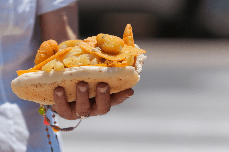 hand holding a panelle sandwich