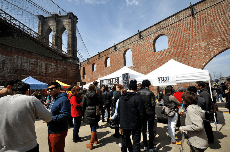 People walking through Smorgasburg food market in Williamsburg, New York City