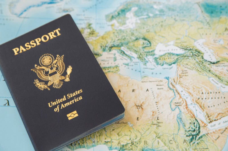 US passport on top of a world map