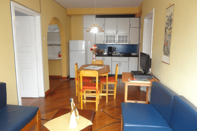traditional apartment in Cuenca, Ecuador. Dinette and sofa, plus cabinets in the distance