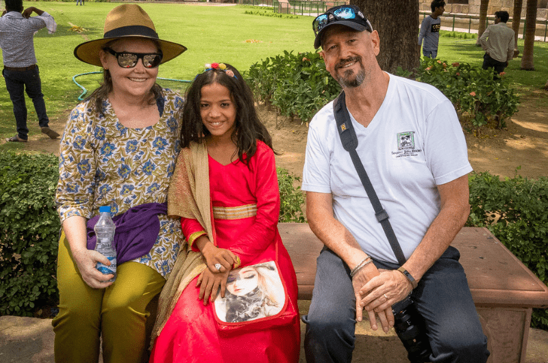 author wearing a Kurti in Delhi, sitting with her husband and a local girl