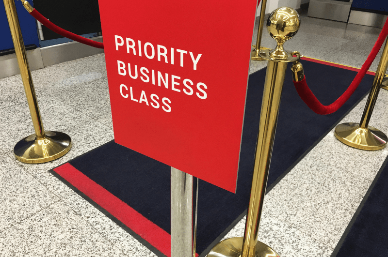 business class priority check-in mat and sign at an airport