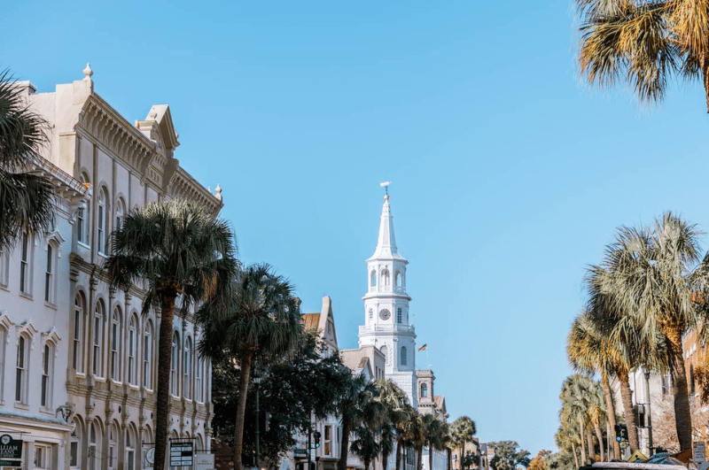 church steeple behind buildings in Charleston