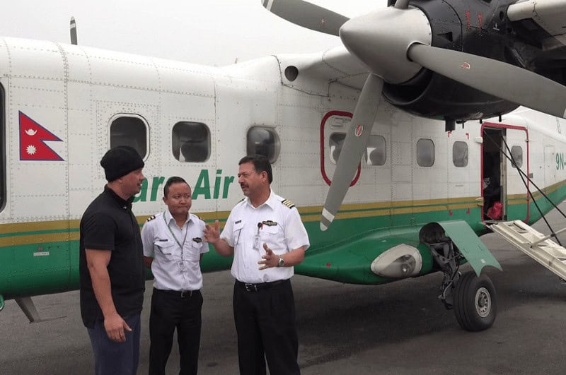 Pilots in front of a plane that travels to Everest Base Camp. 