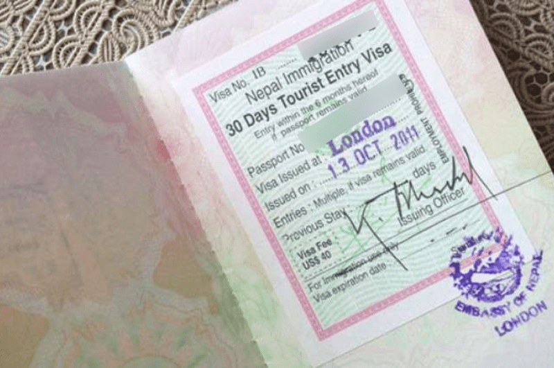 Nepal tourist visa stamp in a UK Passport. The ebc trek cost for a 30 day visa is $50
