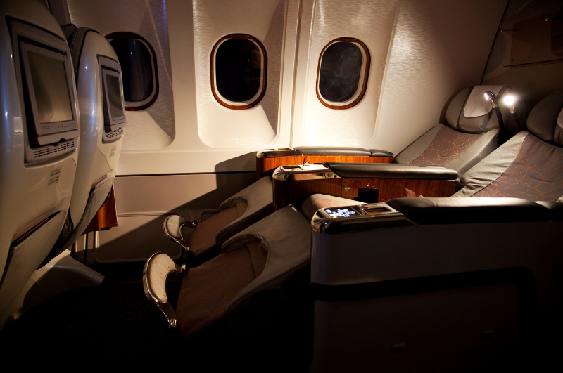 reclining first-class seat illuminated after dark