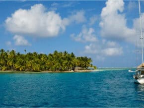 A sailboat next to an island in San Blas Panama