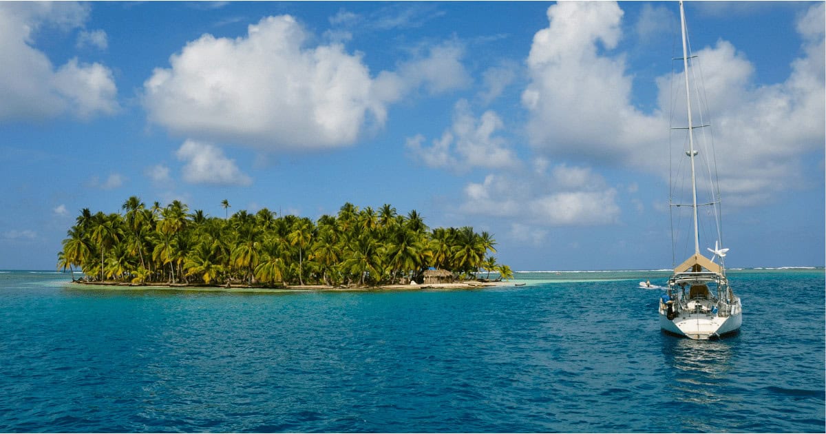 A sailboat next to an island in San Blas Panama