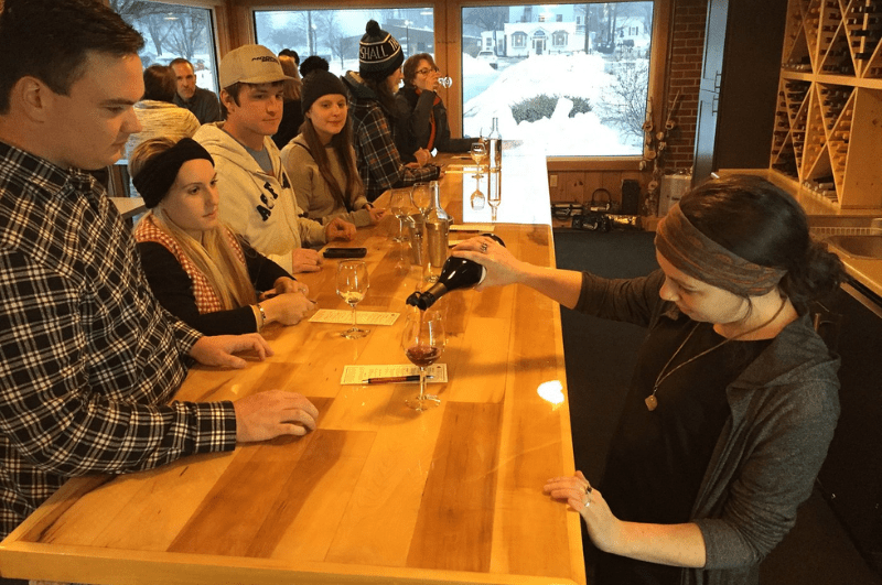 People being served wine at a winery's tasting room