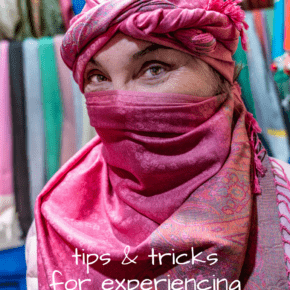 Woman wearing a Moroccan headdress. Text overlay says "tips & tricks for experiencing local culture when you travel."