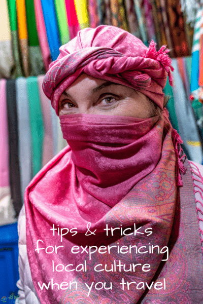 Woman wearing a Moroccan headdress. Text overlay says "tips & tricks for experiencing local culture when you travel."