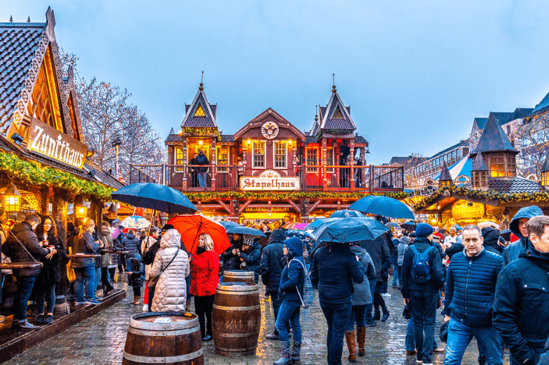 People enjoying a Christmas market in the rain in Cologne Germany