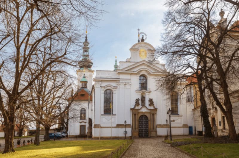 Trees frame the front of Strahov Monastery