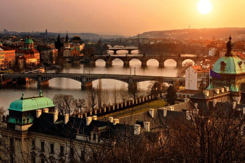 Sunset illuminating the river and buildings in Prague Czech Republic. Prague weekend itinerary inspiration.