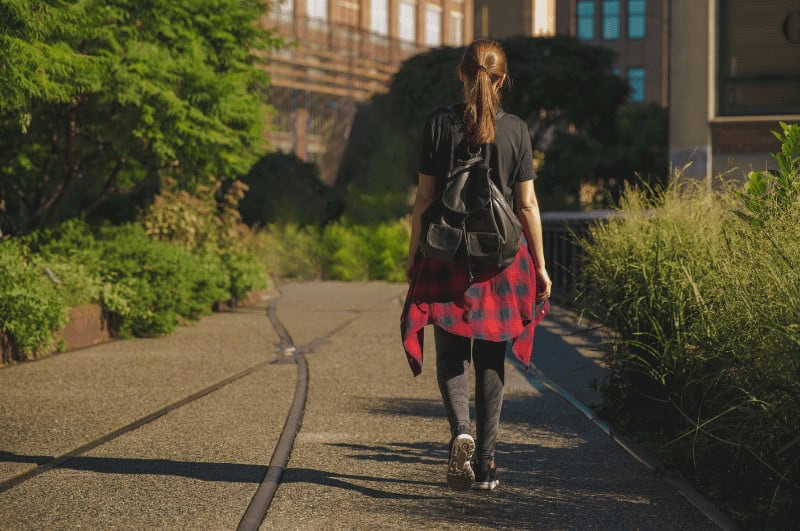 woman walking on a path at The High Line NYC park