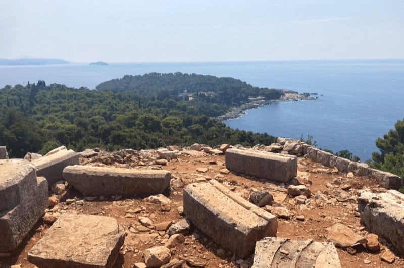 Rocky soil and a view of the wooded area at the end of Lokrum Island