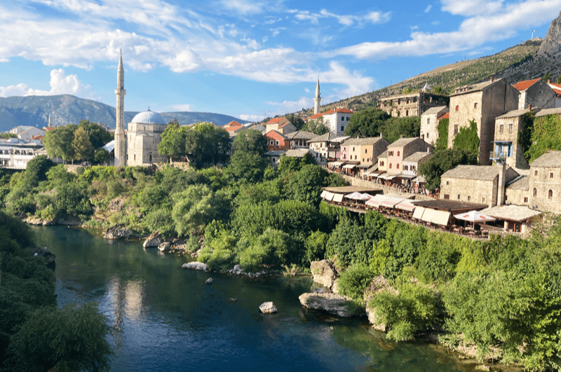 The town of Mostar, in Boxnia and Herzegovina, as seen across the Neretva River. Popular day trip from Dubrovnik and Split.