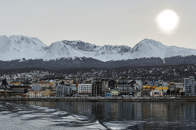 The remote coastal town of Ushuaia Argentina, with Andes Mountains in the background. Many people consider it one of the essential places to visit in Patagonia.