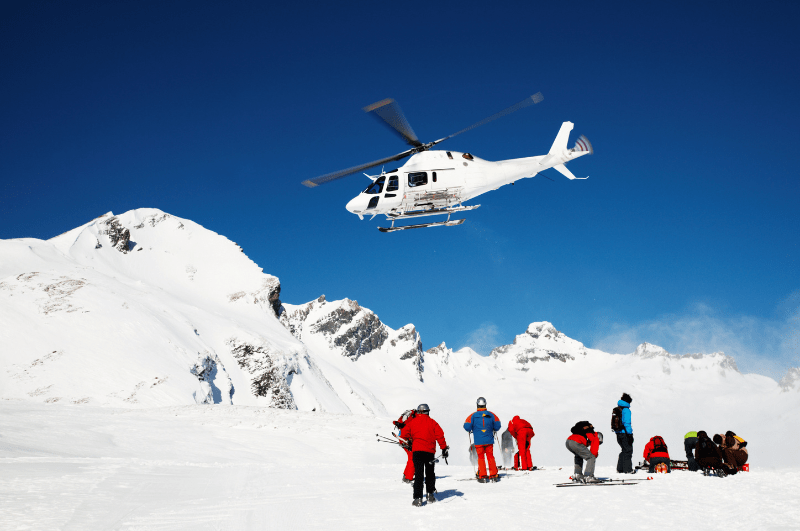people dropped off by heli-skiing helicopter