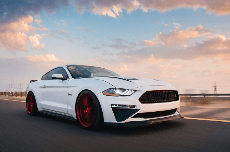 White Ford Mustang at sunset