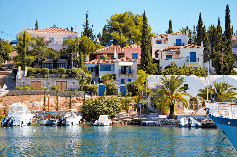 Scenic old harbor on Spetses Island in Greece, with fishing boats and beautiful mansions