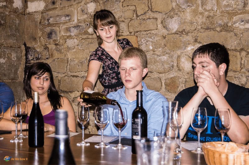 Three people tasting wine in a French chateau in Paris