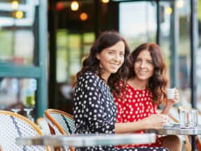 Two women sitting at a cafe in Paris
