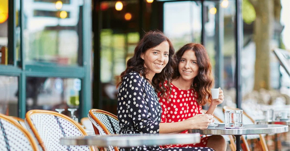 Two women sitting at a cafe in Paris