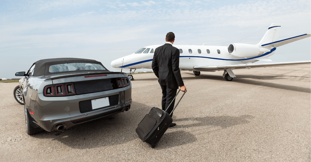 Man leaving his car and approaching a private jet with a carry-on suitcase. Private jet etiquette says you should pack light.