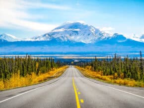 Classic American road trip sight: A road leading to a ountain in the distance
