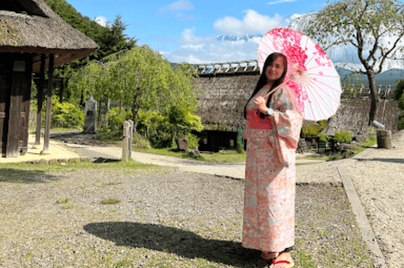 Woman with a parasol and wearing a kimono in Oshino Hakkai on a Tokyo to Mount Fuji day trip