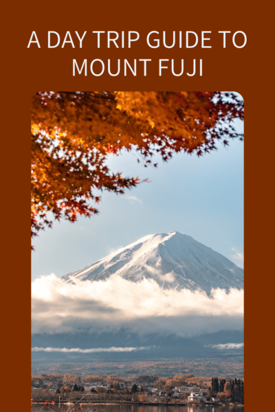 Mount Fuji framed by autumn leaves. Text overlay says "A day trip guide to Mount Fuji"