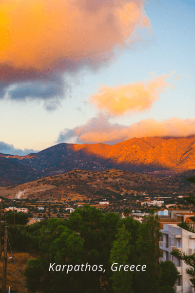 Sunset illuminates the clouds and mountains in Karpathos Greece