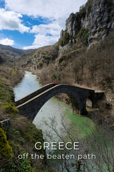 A stone bridge over the water in Zagoria. The text overlay says "Greece off the beaten path"