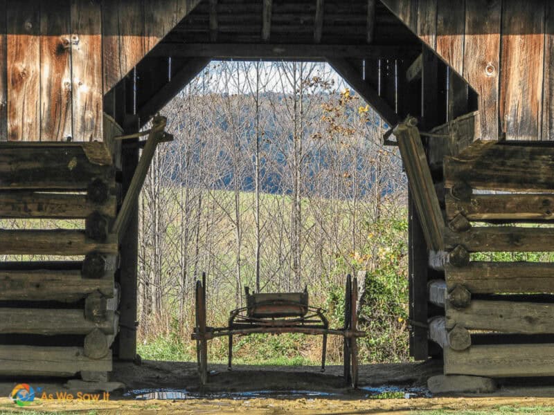 Silhouette of an old wagon in a barn