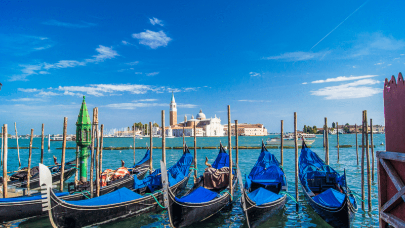 Gondolas lined up along the canal in Venice.