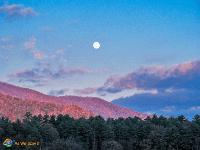 A full moon hangs over Cades Cove in Autumn at twilight