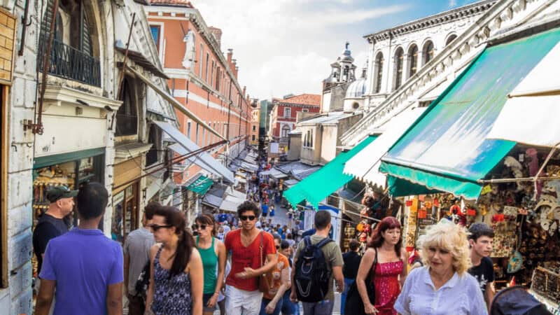 Crowds of tourists on Rialto Bridge in Venice Italy
