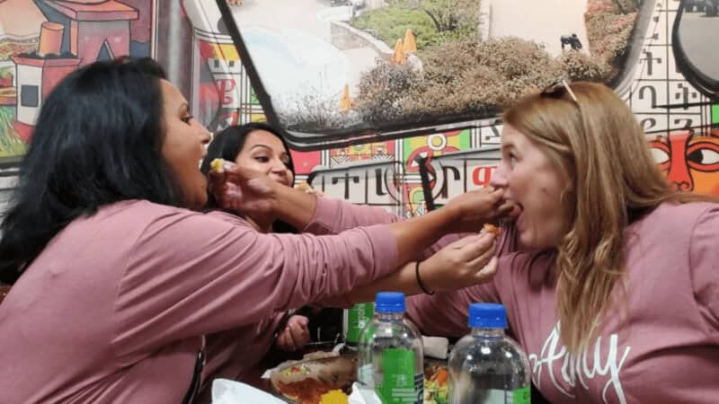 Women sharing food at an outdoor cafe