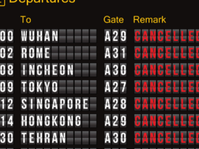 Flight departure billboard showing a bunch of cancelled flights.