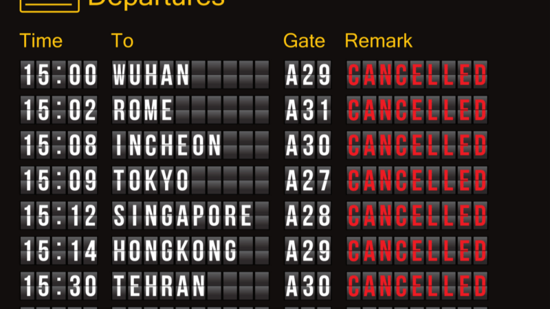 Flight departure billboard showing a bunch of cancelled flights.