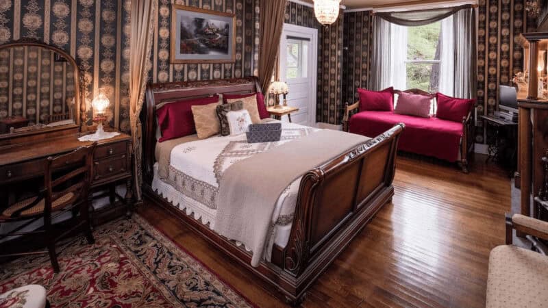 A romantic bedroom with turn-of-the-century decor in The Steamboat House, one of the luxury getaways near Chicago IL.