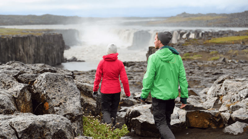 Two people hiking to Selfoss Waterfall, Iceland