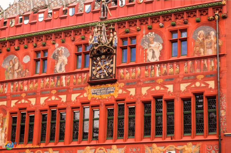 Clock and paintings on the exterior of the Rathaus in Basel.