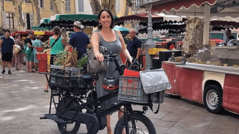 Woman on a bicycle in Provence with the day's groceries in the back.