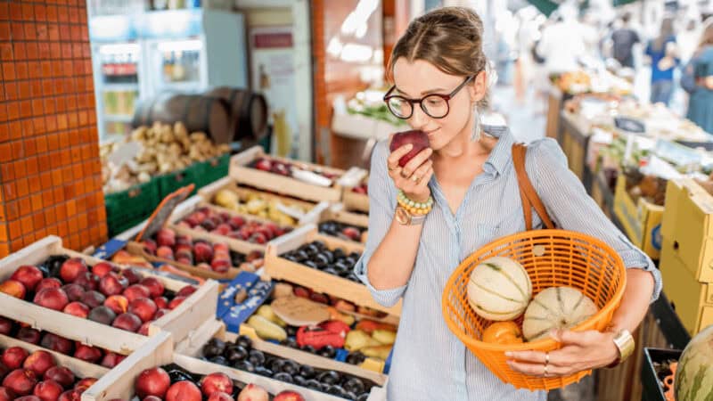 A woman shopping at a local market in France.